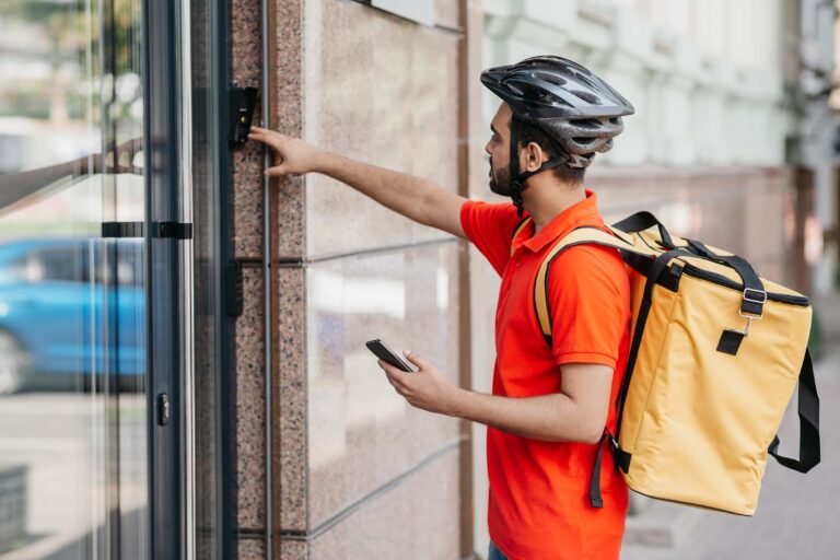 modern-food-delivery-young-man-with-beard-with-bac-NXYW3MJ.jpg